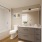 bathroom with tub and large mirror