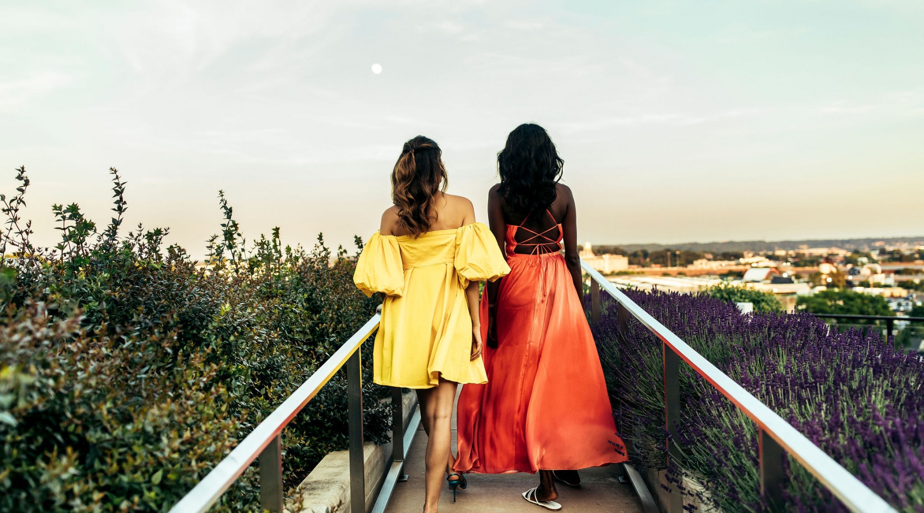 Rooftop  Friends walking on rooftop with sunset views