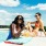 women have drinks in swimming pool