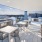 Rooftop patio with bbq area and fire pit overlooking the city with plenty of seating