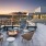 Rooftop patio with bbq area and fire pit overlooking the city with plenty of seating